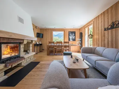 a living room with a couch and a fireplace at Chalet Tannuaz - 4 Bedrooms - Quiet area - By Cozee Rentals in Les Houches