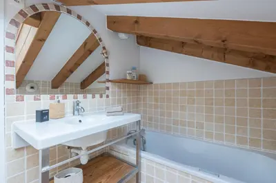 a bathroom with a sink and a bath tub at Spacious duplex with terrace in Les Houches in Les Houches