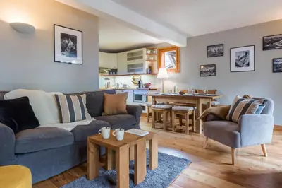 a living room with a couch and a table at Spacious duplex with terrace in Les Houches in Les Houches