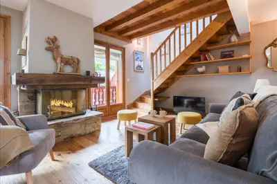 a living room with a couch and a fireplace at Spacious duplex with terrace in Les Houches in Les Houches