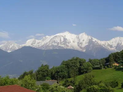a mountain range with snow capped mountains in the distance at Gite Le sommet in Sallanches
