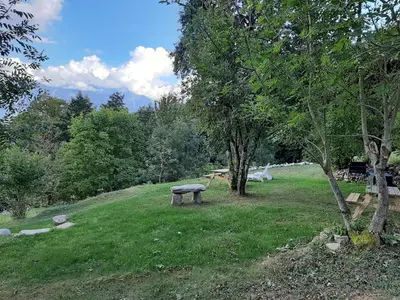 a park with a bench in the middle of a field at Gite Le sommet in Sallanches