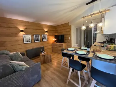a kitchen and living room with a couch and a table at Beautiful cozy and fully renovated apartment in Chamonix-Mont-Blanc