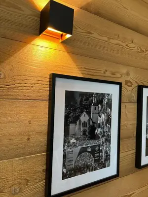 a black and white picture on a wall with a light at Beautiful cozy and fully renovated apartment in Chamonix-Mont-Blanc
