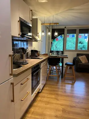 a kitchen and living room with a table and a couch at Beautiful cozy and fully renovated apartment in Chamonix-Mont-Blanc