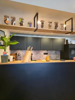 a kitchen with a wooden counter top in a room at Appartement atypique au cœur de Sallanches in Sallanches