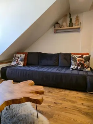 a kitchen with wooden floors and a living room at Appartement atypique au cœur de Sallanches in Sallanches