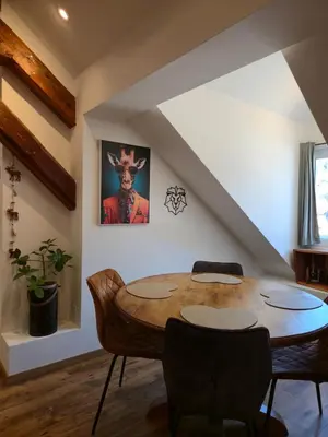 a living room with a table and chairs and a christmas tree at Appartement atypique au cœur de Sallanches in Sallanches