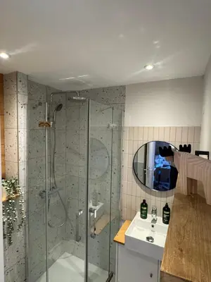 a bathroom with a shower and a sink and a mirror at Charming studio with balcony in Samoëns
