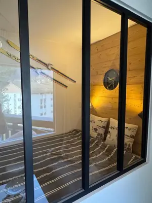 a view of a bedroom through a window at Charming studio with balcony in Samoëns