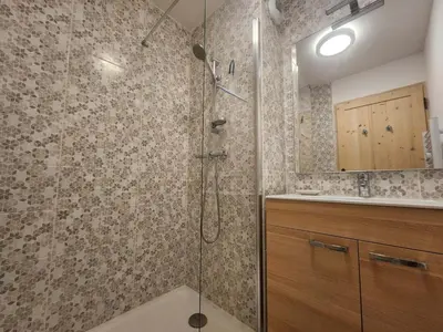 a bathroom with a shower with a glass door at Charmant T2 cabine exposé Ouest avec parking couvert - FR-1-629-148 in Samoëns