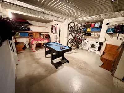 a room with a ping pong table in a garage at Logan - Appartement spacieux 4 chambres - Animaux acceptés - Parking - FR-1-343-266 in Les Houches