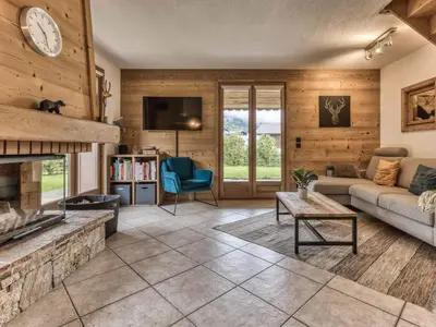 a living room with a couch and a fireplace at Logan - Appartement spacieux 4 chambres - Animaux acceptés - Parking - FR-1-343-266 in Les Houches