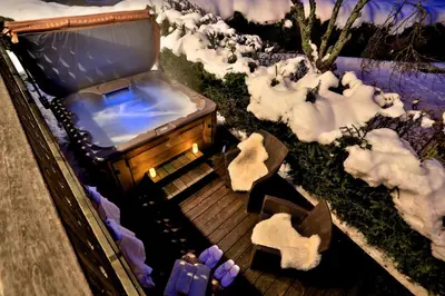 an aerial view of a bath tub in a snow covered yard at Chalet Cristalliers - 5 Bedroom luxury chalet in central Chamonix with log fire and hot tub in Chamonix-Mont-Blanc