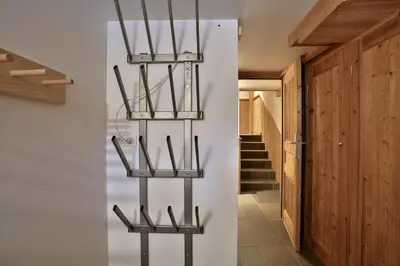 a room with a wall with three metal shelves at Chalet Cristalliers - 5 Bedroom luxury chalet in central Chamonix with log fire and hot tub in Chamonix-Mont-Blanc