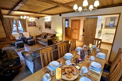a living room with a table with food on it at Chalet Cristalliers - 5 Bedroom luxury chalet in central Chamonix with log fire and hot tub in Chamonix-Mont-Blanc