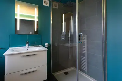 a bathroom with a white sink and a shower at Chalet des Cimes - Chamonix All Year in Chamonix-Mont-Blanc