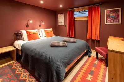 a bedroom with a large bed and a window at Chalet des Cimes - Chamonix All Year in Chamonix-Mont-Blanc