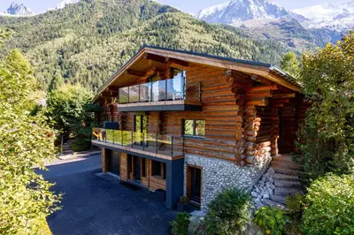 an aerial view of a log house with mountains in the background at Chalet des Cimes - Chamonix All Year in Chamonix-Mont-Blanc