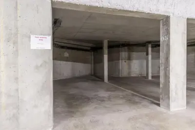an empty parking garage with concrete walls and columns at Appartement moderne - Les houches in Les Houches