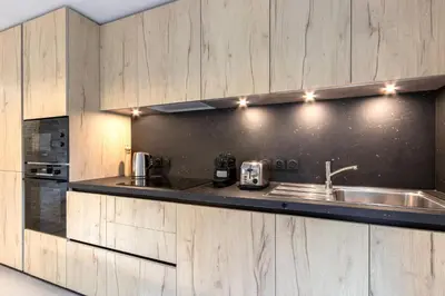 a kitchen with a sink and a counter at Appartement moderne - Les houches in Les Houches
