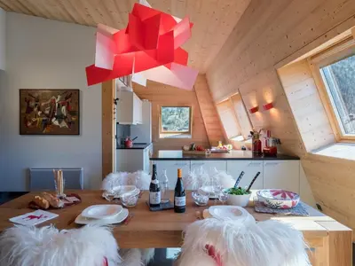 a dining room with a table with red bows at Penthouse Le Paradis I Le Chalet Club in Chamonix-Mont-Blanc