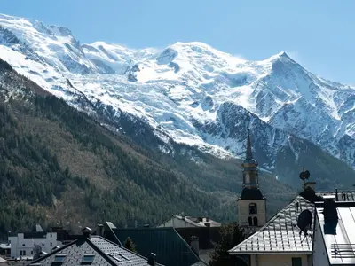 a view of a snow covered mountain with a church at Penthouse Le Paradis I Le Chalet Club in Chamonix-Mont-Blanc