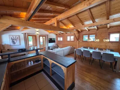 a large room with a table and chairs in it at Grand appartement proche centre in Megève