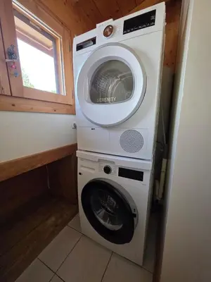 a washer and dryer in a tiny house at Grand appartement proche centre in Megève