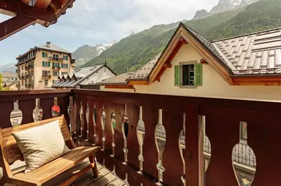a bench on a balcony with a view of mountains at Val d'Arve Apartment - Chamonix All Year in Chamonix-Mont-Blanc
