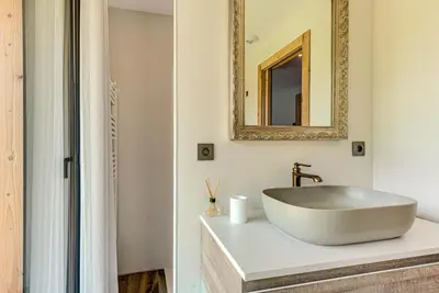 a bathroom with a white sink and a mirror at Chalet Papillon - Alpes Travel - Detached Chalet - Les Praz - Sleeps 8-10 in Chamonix-Mont-Blanc
