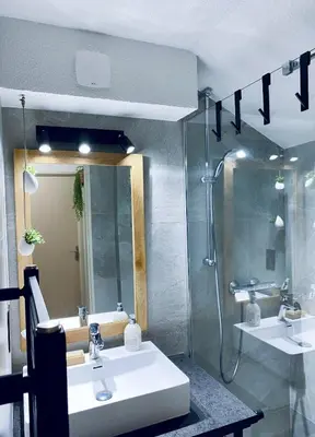 a bathroom with a sink and a shower and a mirror at 3 cows in Les Contamines-Montjoie