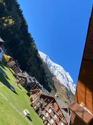 a group of buildings on the side of a mountain at 3 cows in Les Contamines-Montjoie