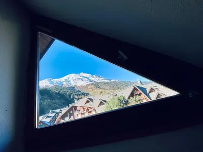 a window in a room with a view of a mountain at 3 cows in Les Contamines-Montjoie