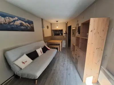 a wooden table and bench in a kitchen with a counter at Cham sud in Chamonix-Mont-Blanc