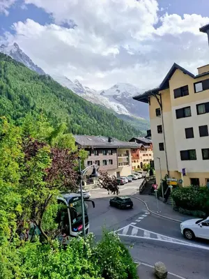 a street in a town with mountains in the background at Cham sud in Chamonix-Mont-Blanc