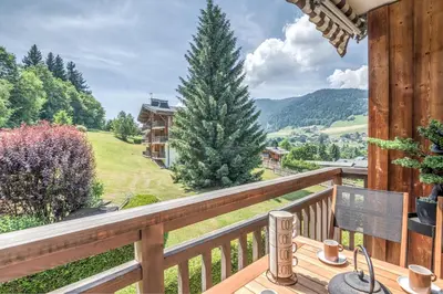 a wooden balcony with a view of a mountain at Appartement Le clos de Rochebrune - Welkeys in Megève