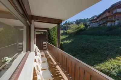 a porch with benches and a view of a field at Résidence Le Relax - Megève Centre in Megève