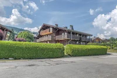 a house with bushes in front of it at Appartement Warens - Welkeys in Megève