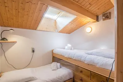 a room with two bunk beds and a window at Appartement Warens - Welkeys in Megève