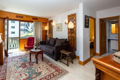 a living room with a couch and a table at Le Brevent apartment -Chamonix All Year in Chamonix-Mont-Blanc