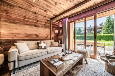 a living room with a couch and a table at Apartment Brume Megève - by EMERALD STAY in Megève
