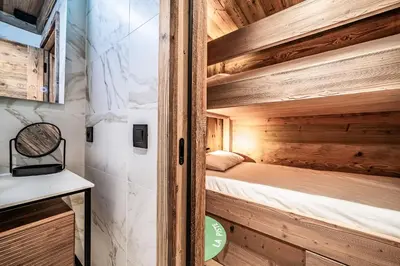 a bedroom in a tiny house with a bunk bed at Apartment Brume Megève - by EMERALD STAY in Megève