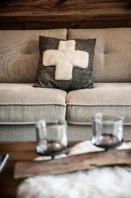 a living room with a couch with two glasses on a table at Apartment Brume Megève - by EMERALD STAY in Megève