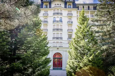 a large white building with trees in front of it at Le Majestic 76 - Chamonix All Year in Chamonix-Mont-Blanc