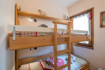 a couple of bunk beds in a tiny house at Studio Montée du Calvaire - Welkeys in Megève