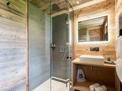 a bathroom with a shower and a sink at Chalet Double M I Le Chalet Club in Combloux