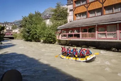 a group of people in a raft on a river at Lou Lou Apartment - Chamonix All Year in Chamonix-Mont-Blanc