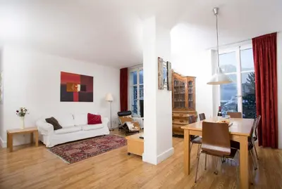 a living room with a white couch and a table at Mont Blanc 98 Apartment - Chamonix All Year in Chamonix-Mont-Blanc