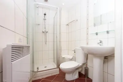 a bathroom with a toilet and a sink and a shower at Mont Blanc 98 Apartment - Chamonix All Year in Chamonix-Mont-Blanc